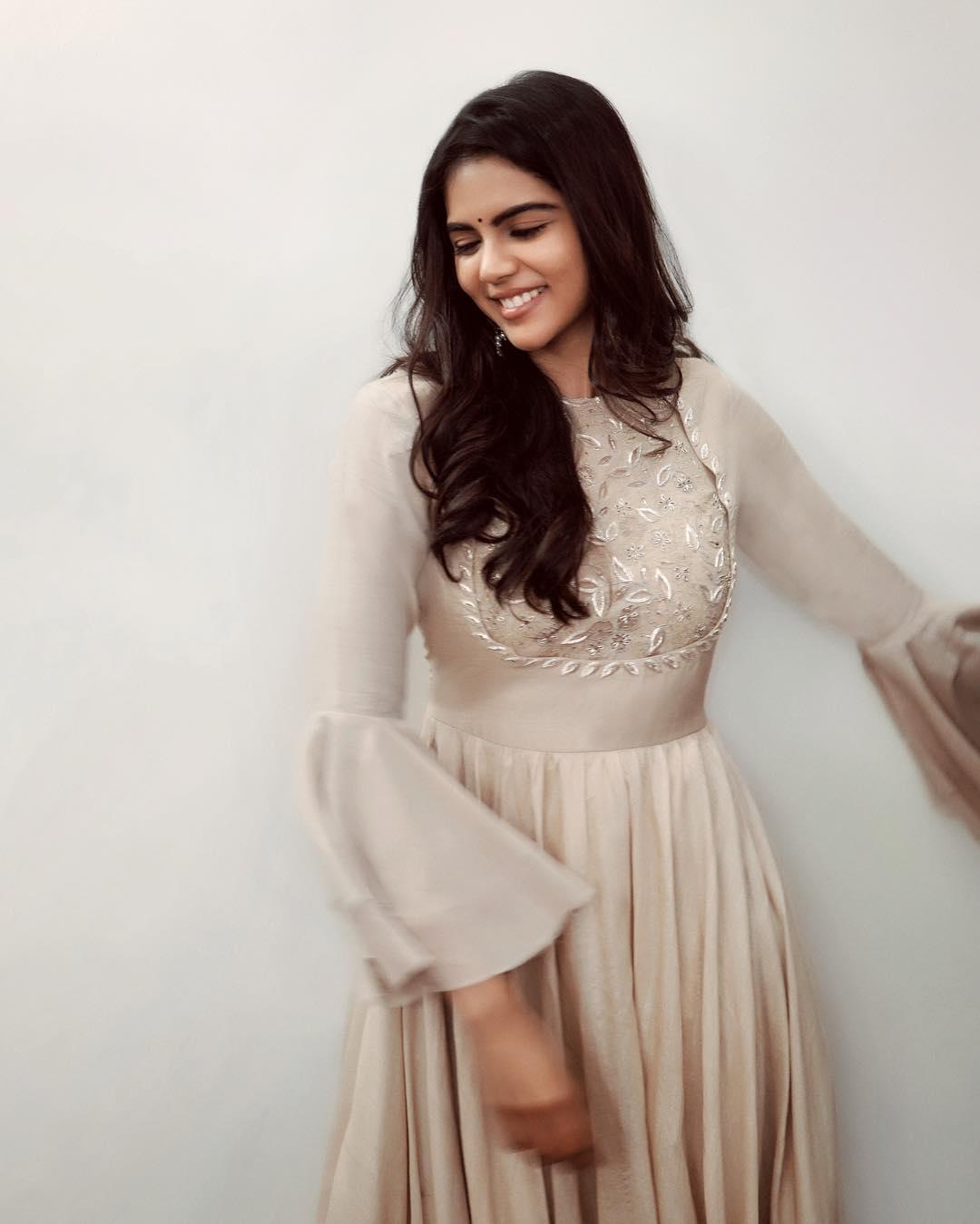 Kalyani Priyadarshan smiling in flared white gown Photo