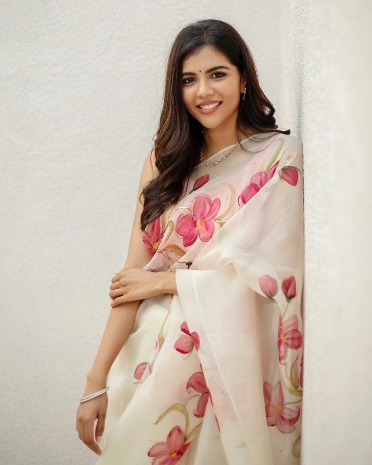 Kalyani Priyadarshan Smiling in Floral White Saree Wallpaper
