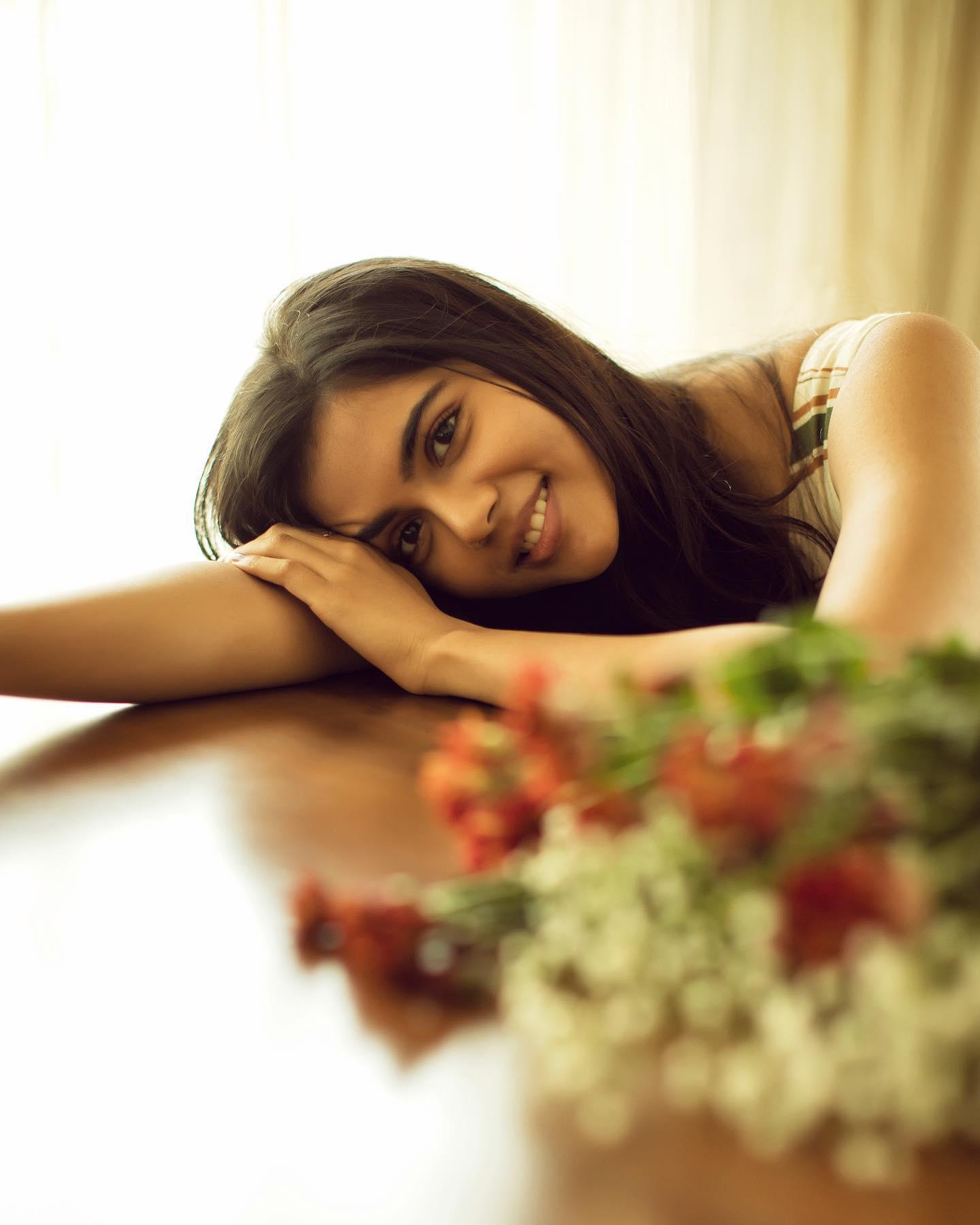 Kalyani Resting Head on Table with Flowers Photography