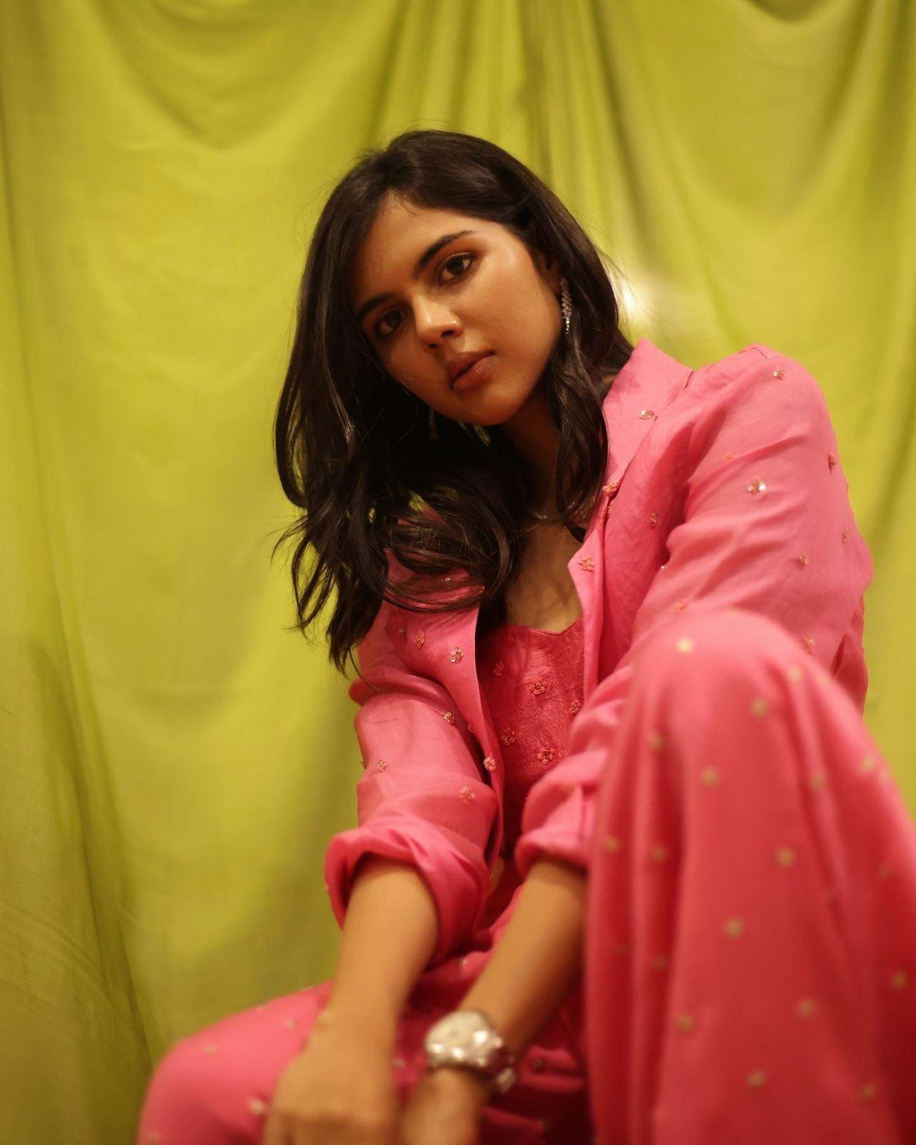 Priyadarshan in Pink Dress with Green Background Wallpaper