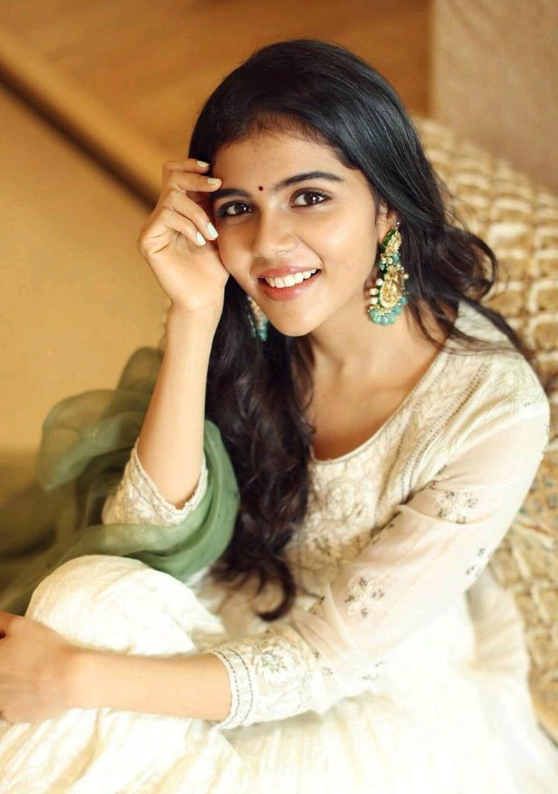 Priyadarshan in White Dress Smiling Sitting Down Photography
