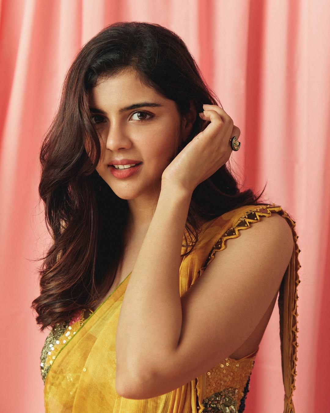 Priyadarshan in Yellow Saree Smiling Near Curtain free Image