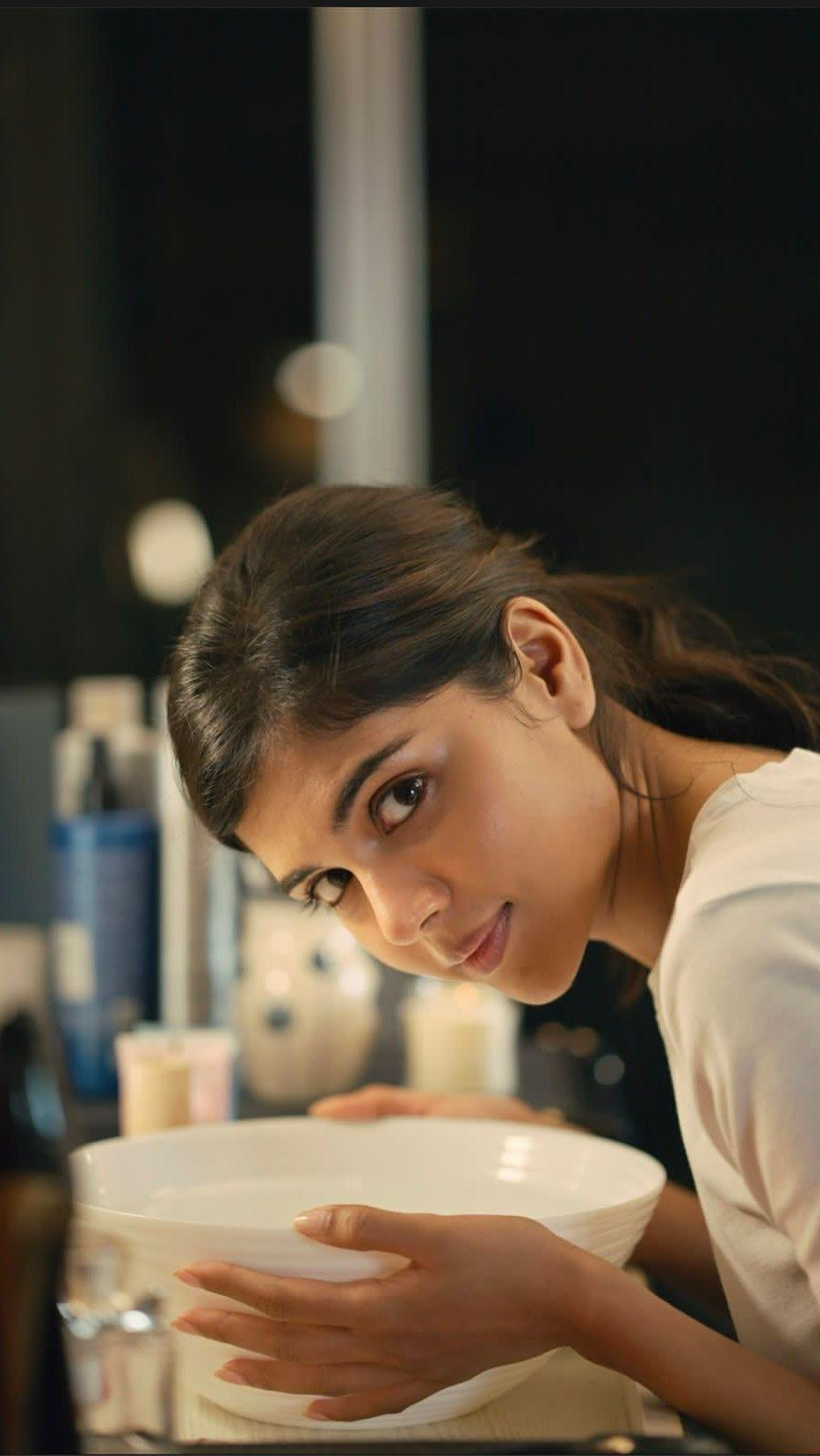 Priyadarshan Leaning Over Kitchen Counter Smiling Image