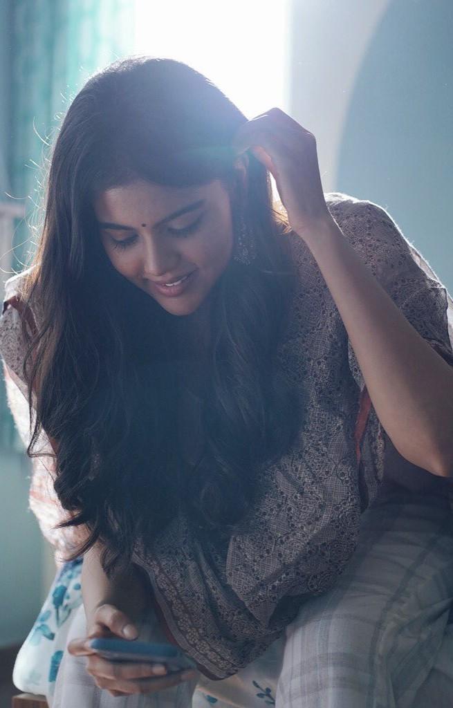 Priyadarshan Looking at Phone in Cozy Morning Light Image