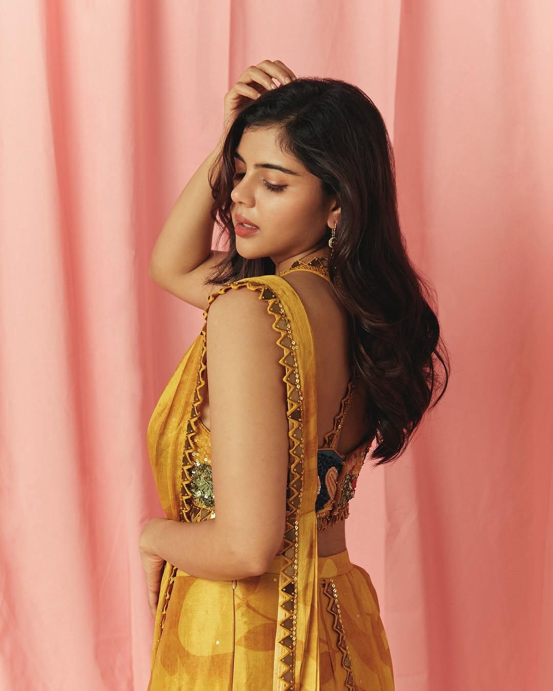 Side View Priyadarshan in Yellow Saree with Pink Backdrop
