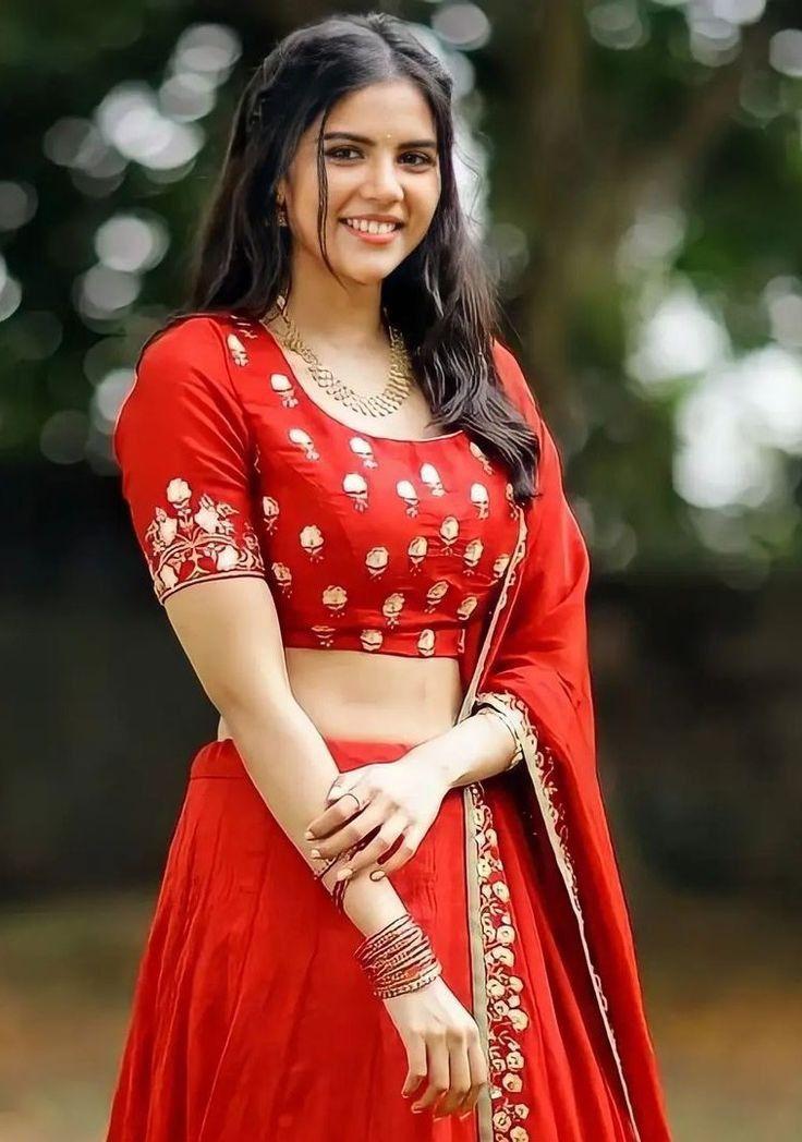 Smiling Kalyani in Red Lehenga in Outdoor Setting Image