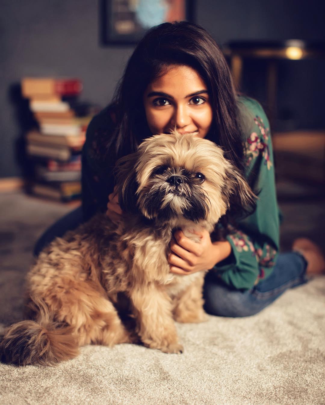 Smiling Priyadarshan with Dog on Carpet Cute Moment Image