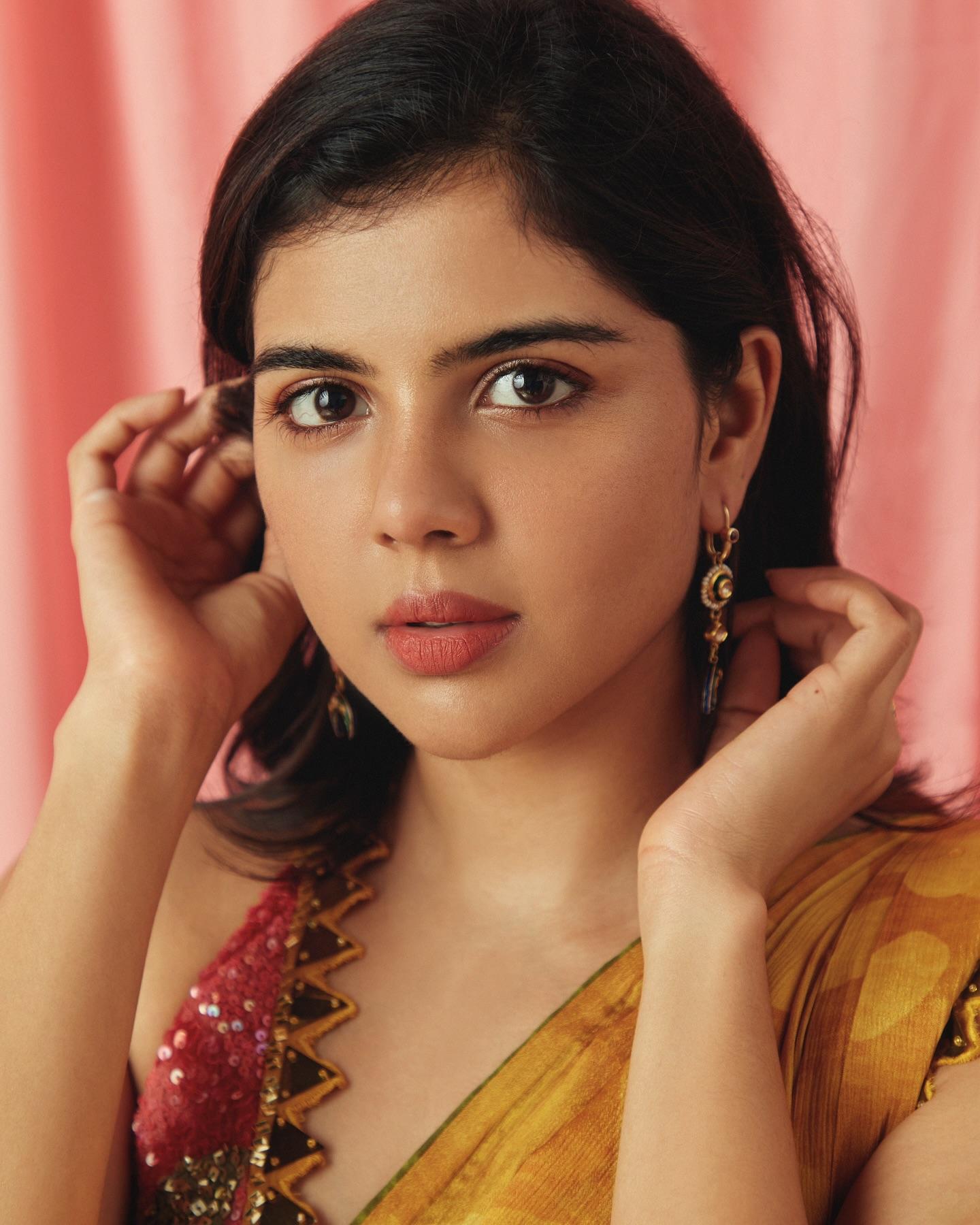 Stunning Pose of Kalyani Priyadarshan with Peach Backdrop