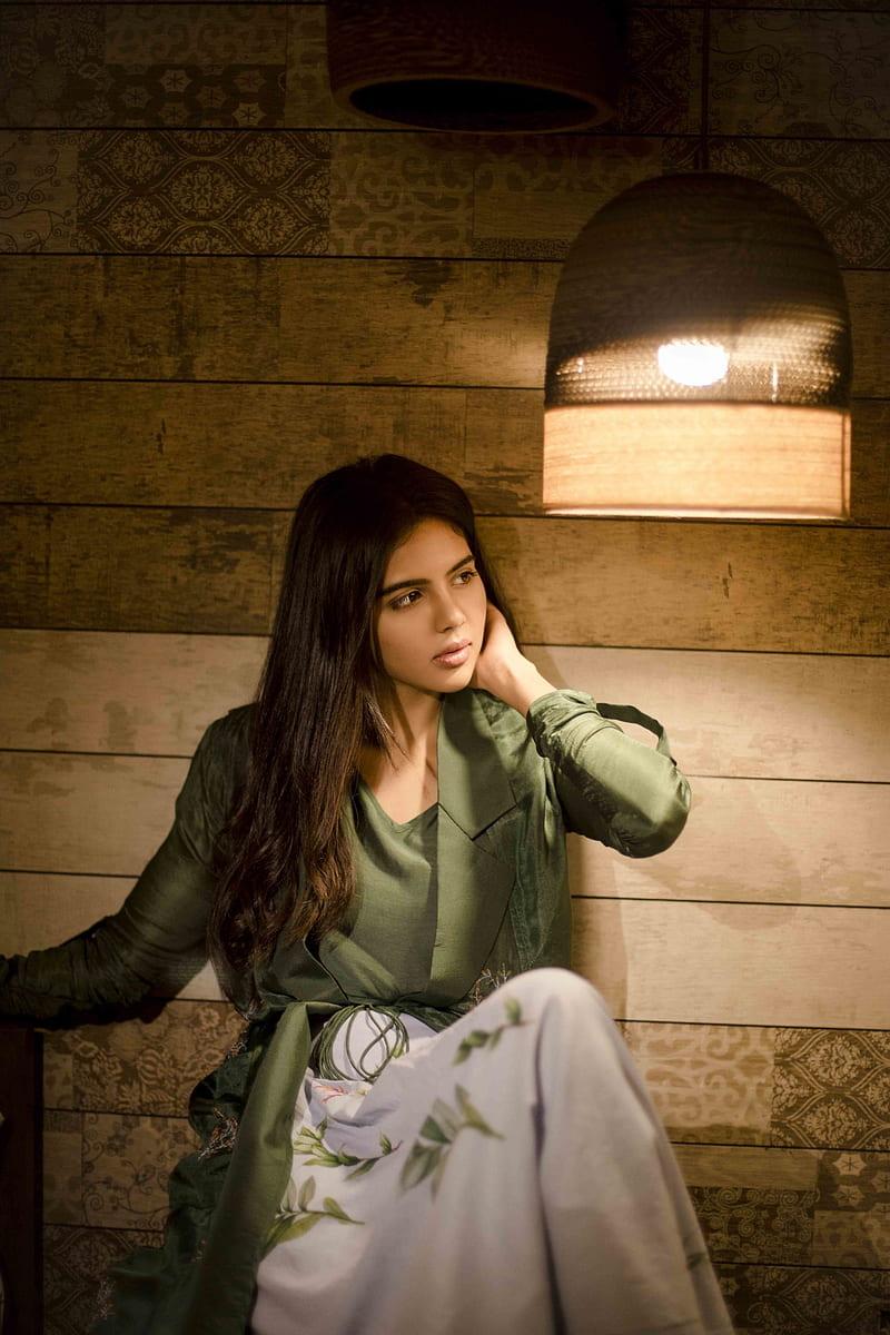 Thoughtful Priyadarshan in Green Saree Under Warm Light Pic