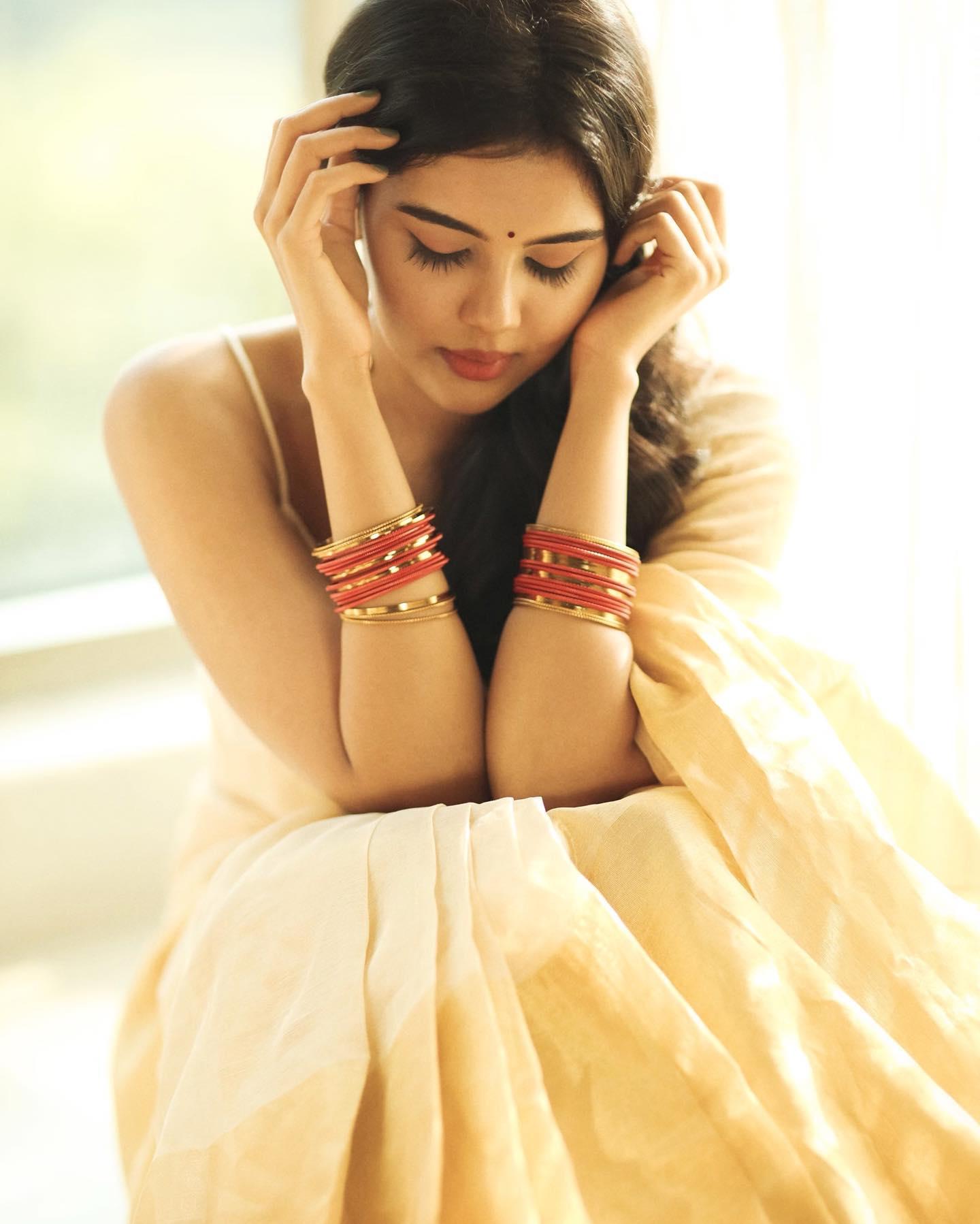 Thoughtful Priyadarshan in Soft Yellow Saree Pose Image