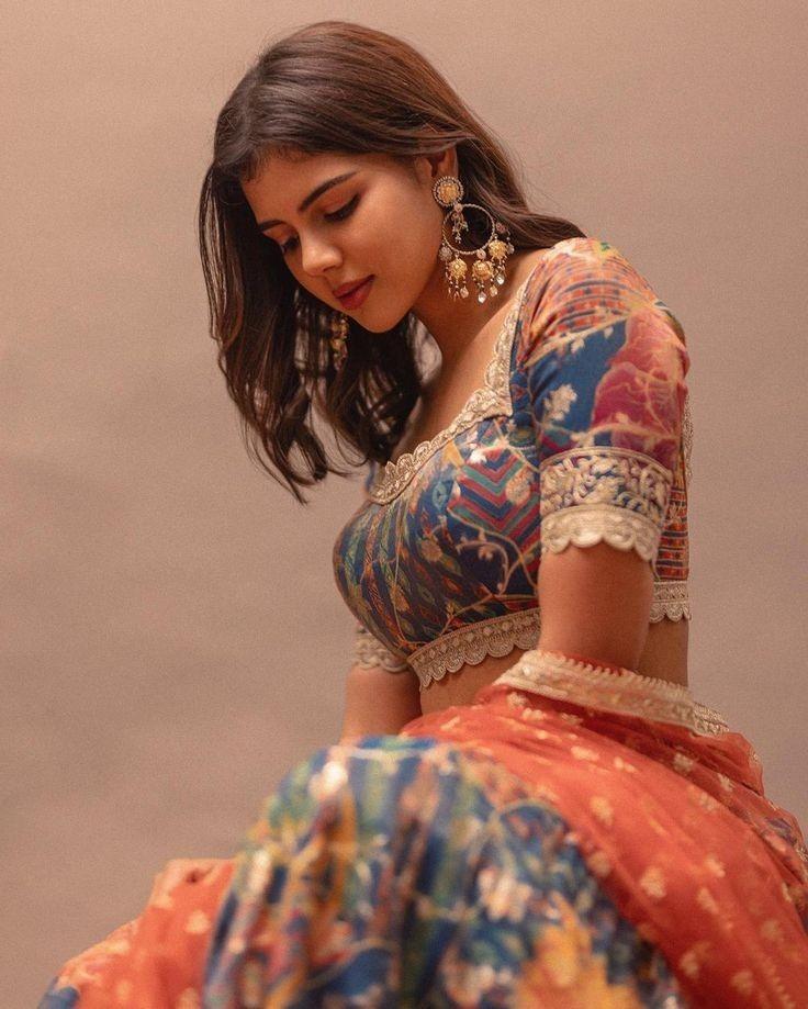 Traditional Look in Colorful Lehenga Seated Sideways Pic