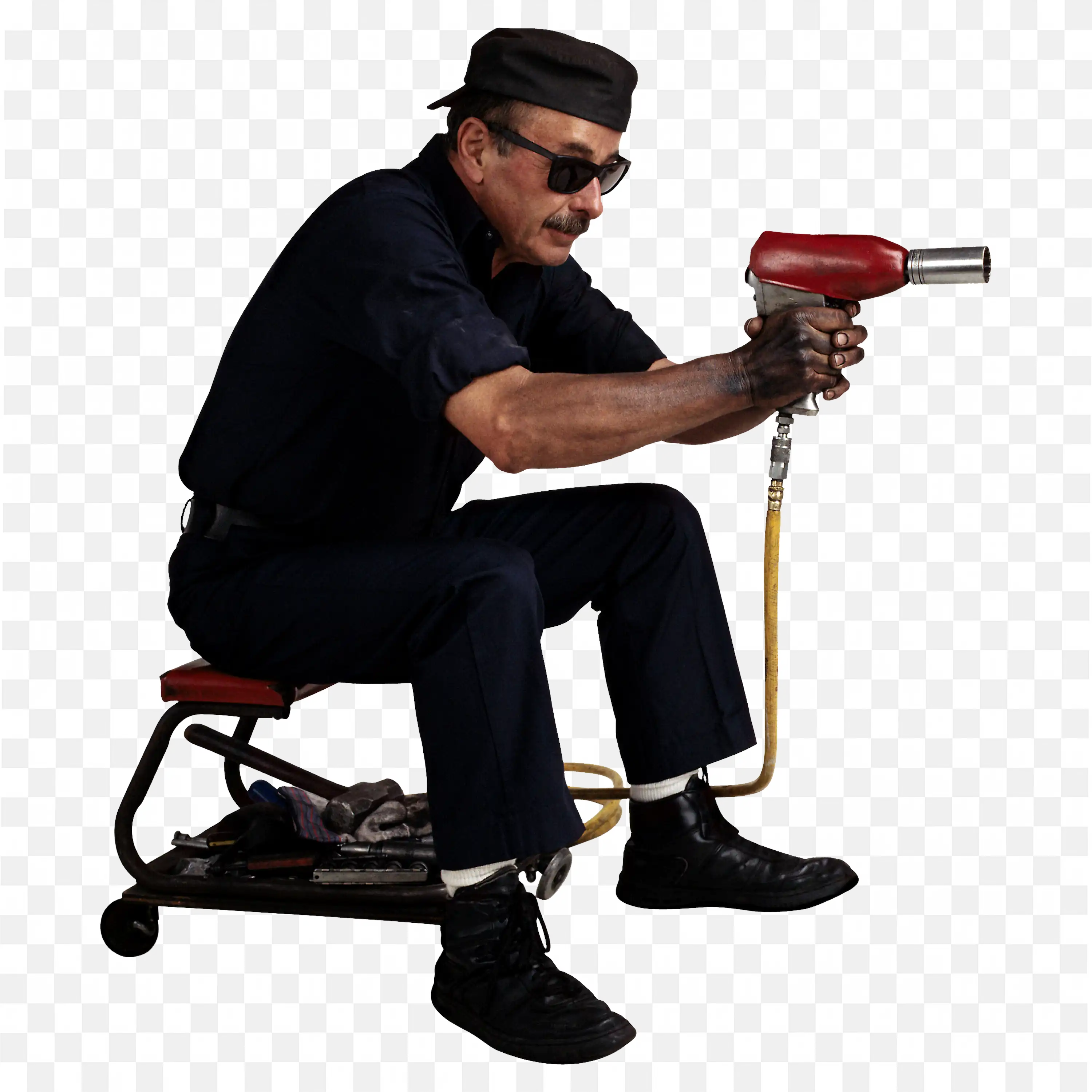 Mechanic Seated on Stool in Uniform and Using an Air Tool