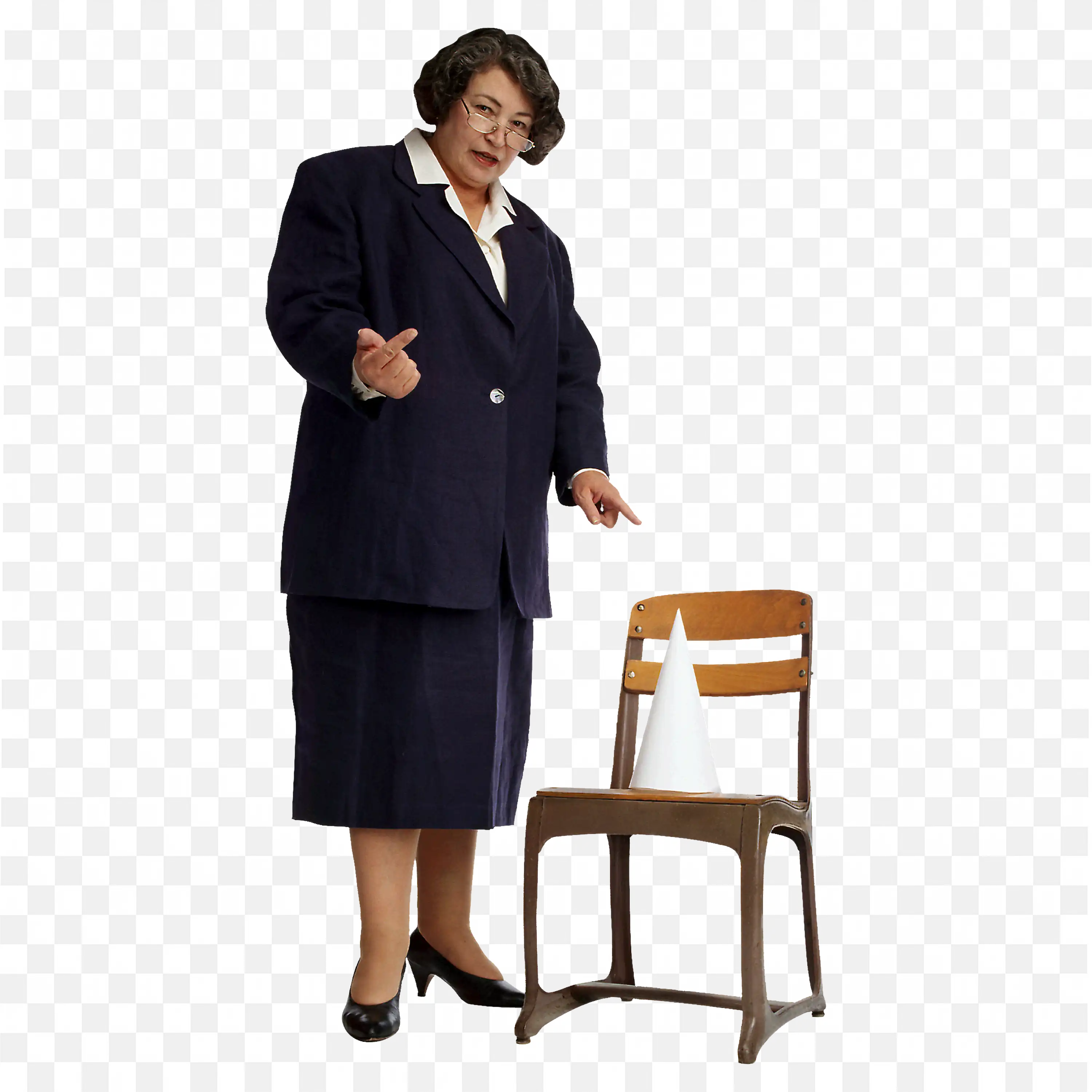 Teacher in a Navy Suit Pointing at the Cone on a Chair