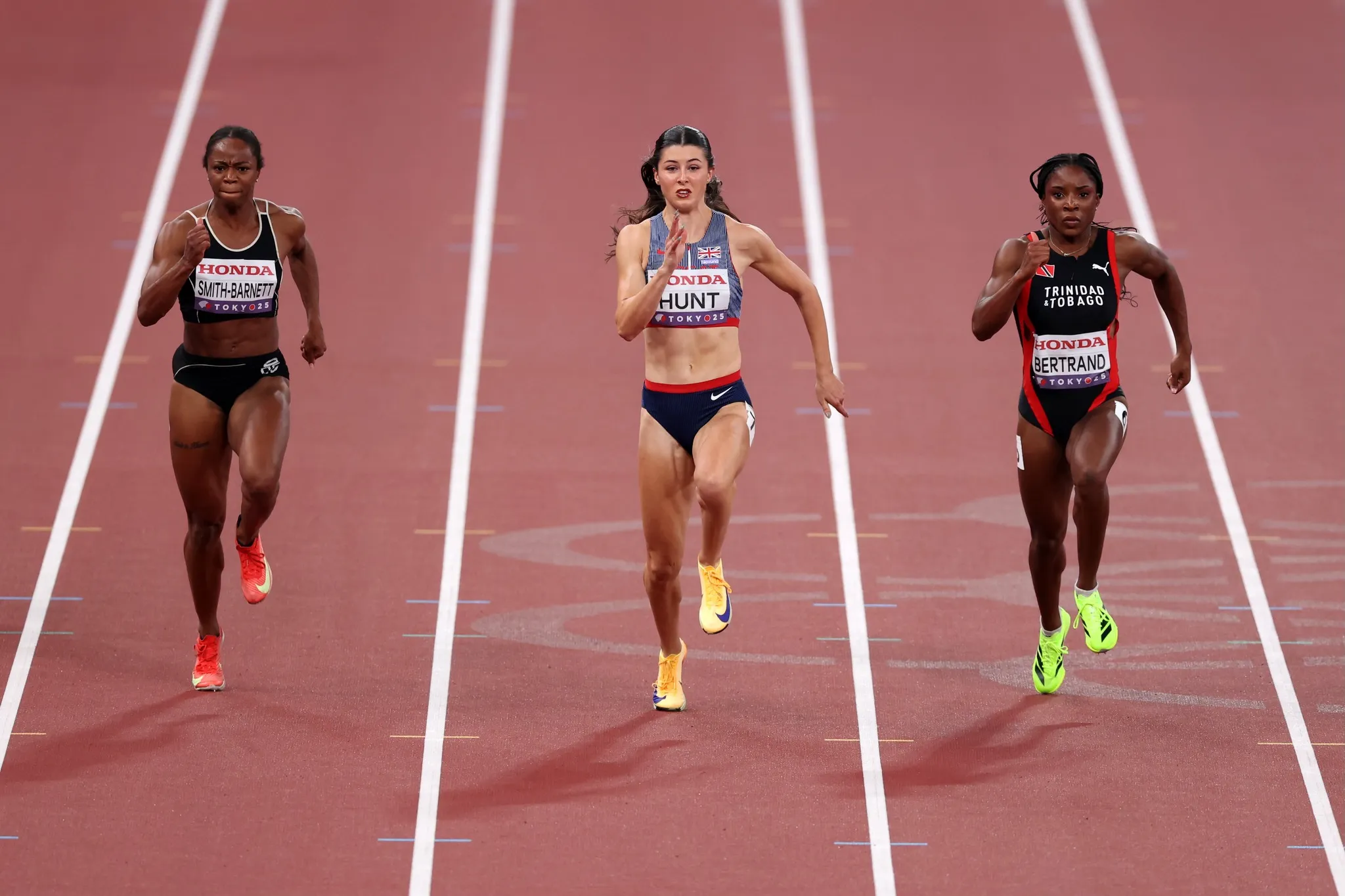 Julien Alfred sprinting side by side with world-class rivals
