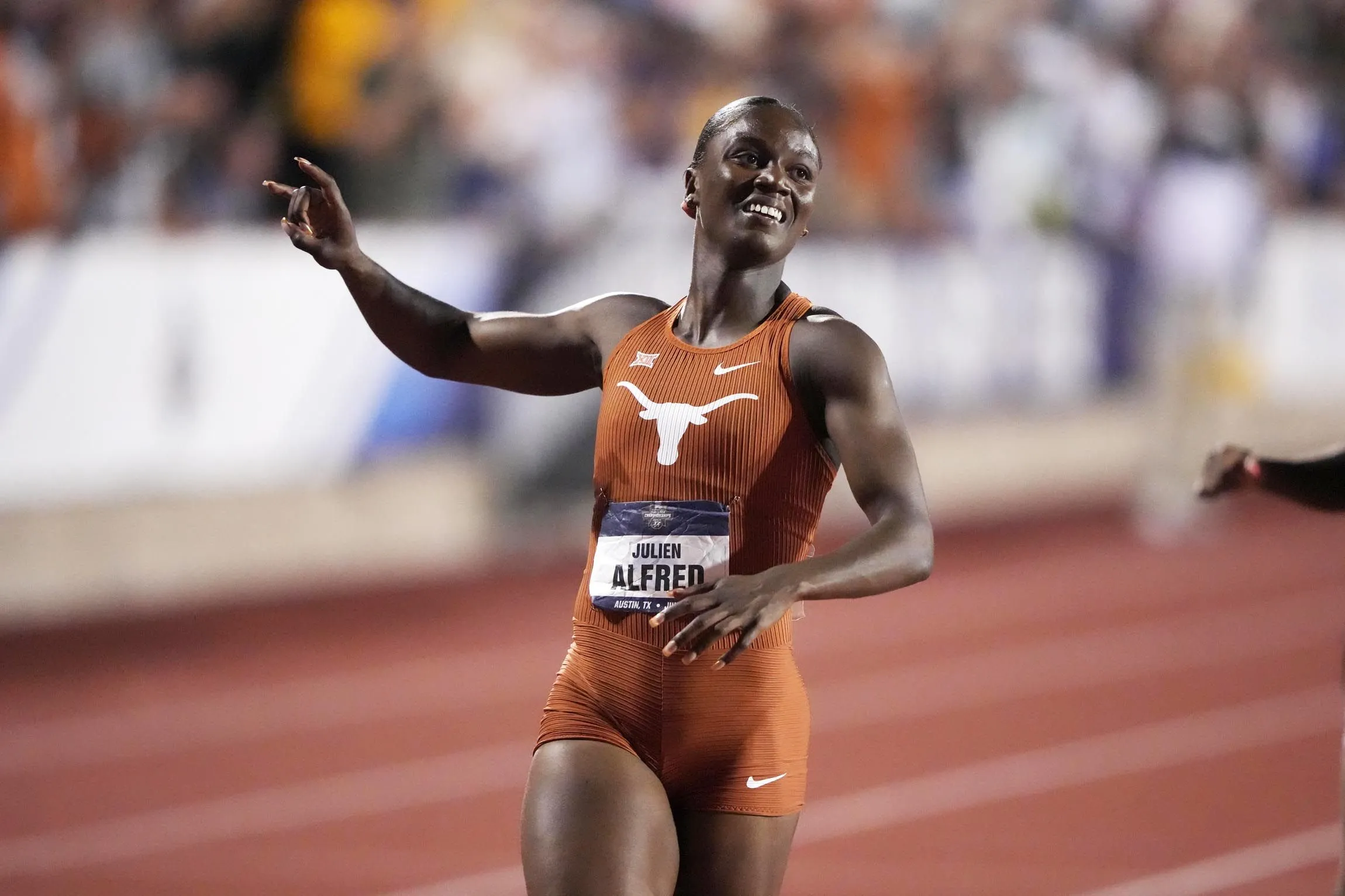 Julien Alfred running at full pace in sprint competition
