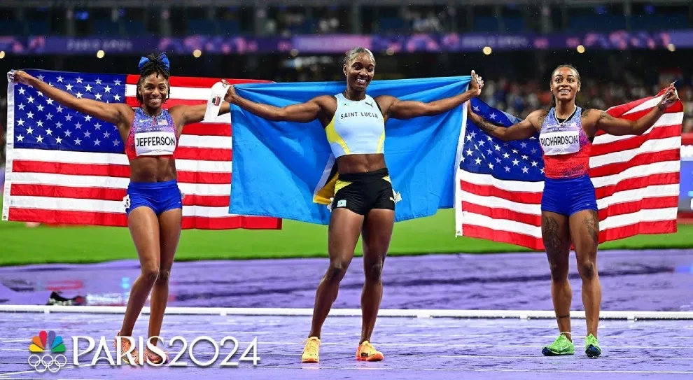 Julien Alfred celebrates victory with national flag on track