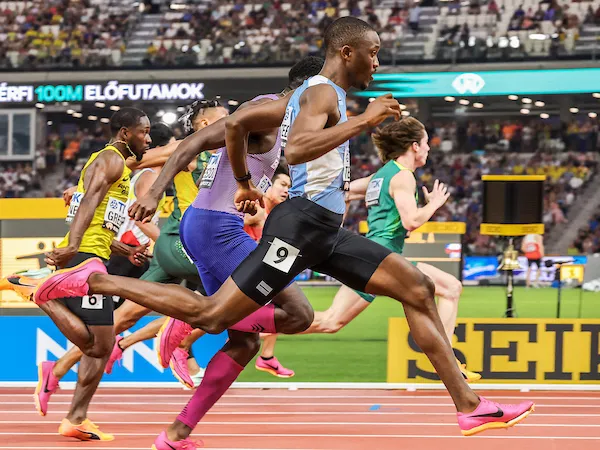 Letsile Tebogo sprinting in a competitive athletics race event