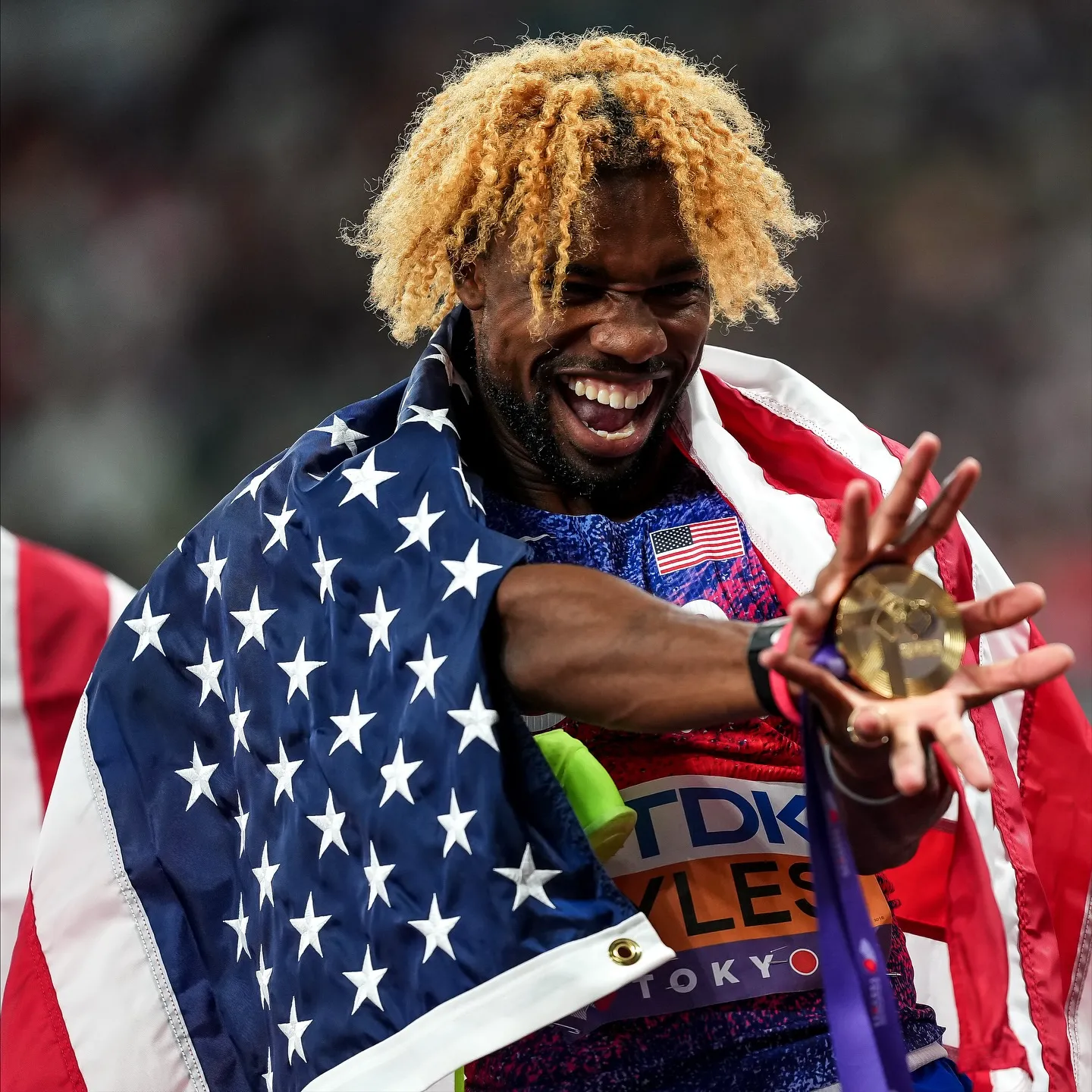 Noah Lyles Wraps in US Flag After Victory