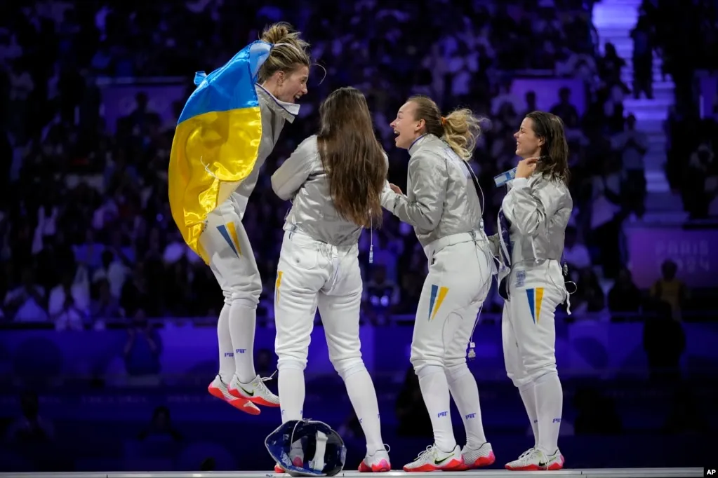 OlhaKharlan Carries Ukraine Flag at Ceremony