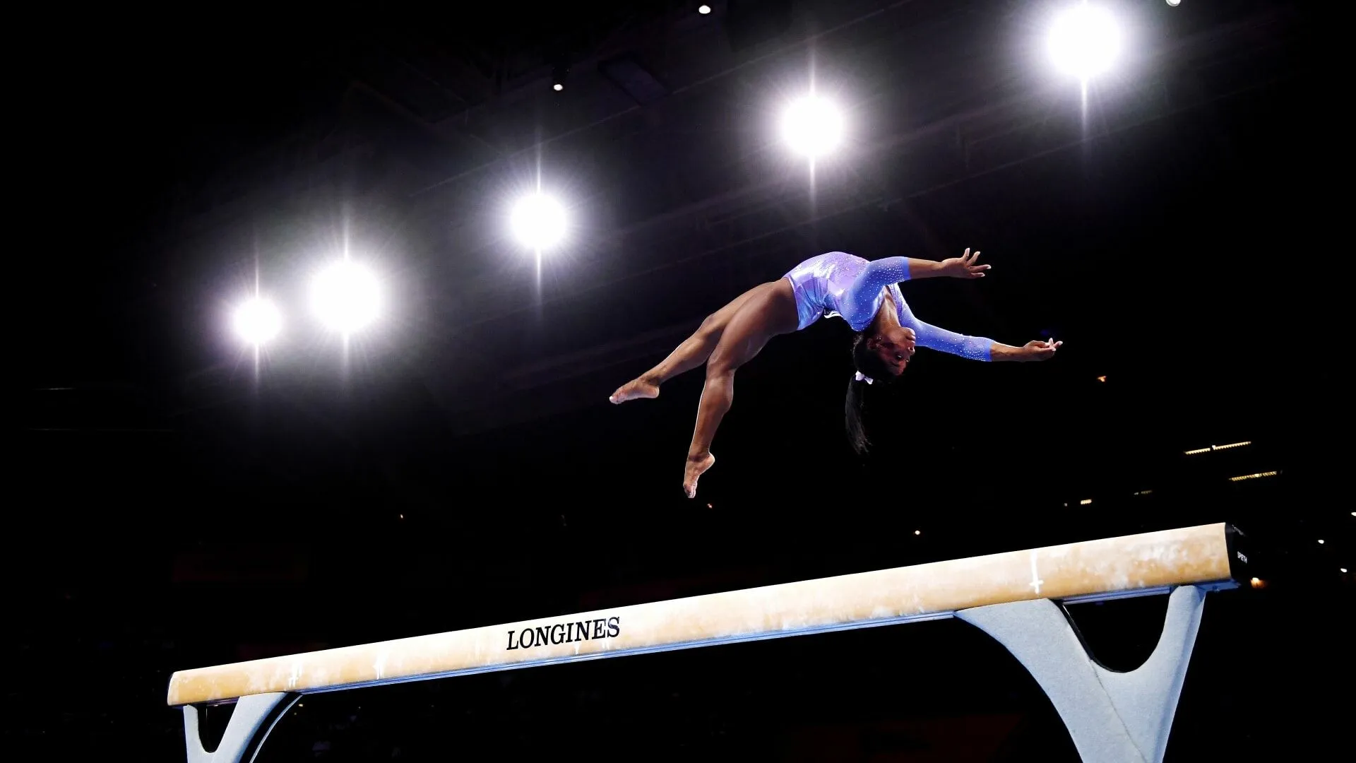 Simone Biles Gymnastics Vault in Mid Air Wallpaper