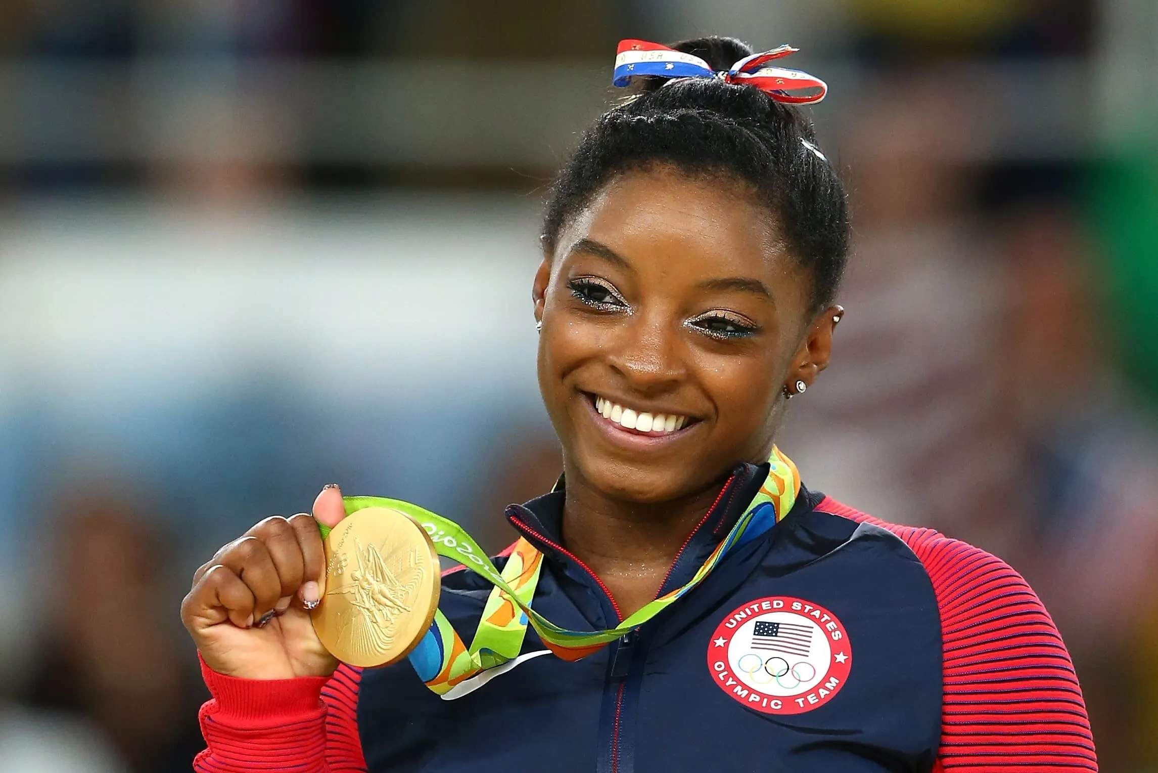 Simone Biles Smiling With Medal Wallpaper