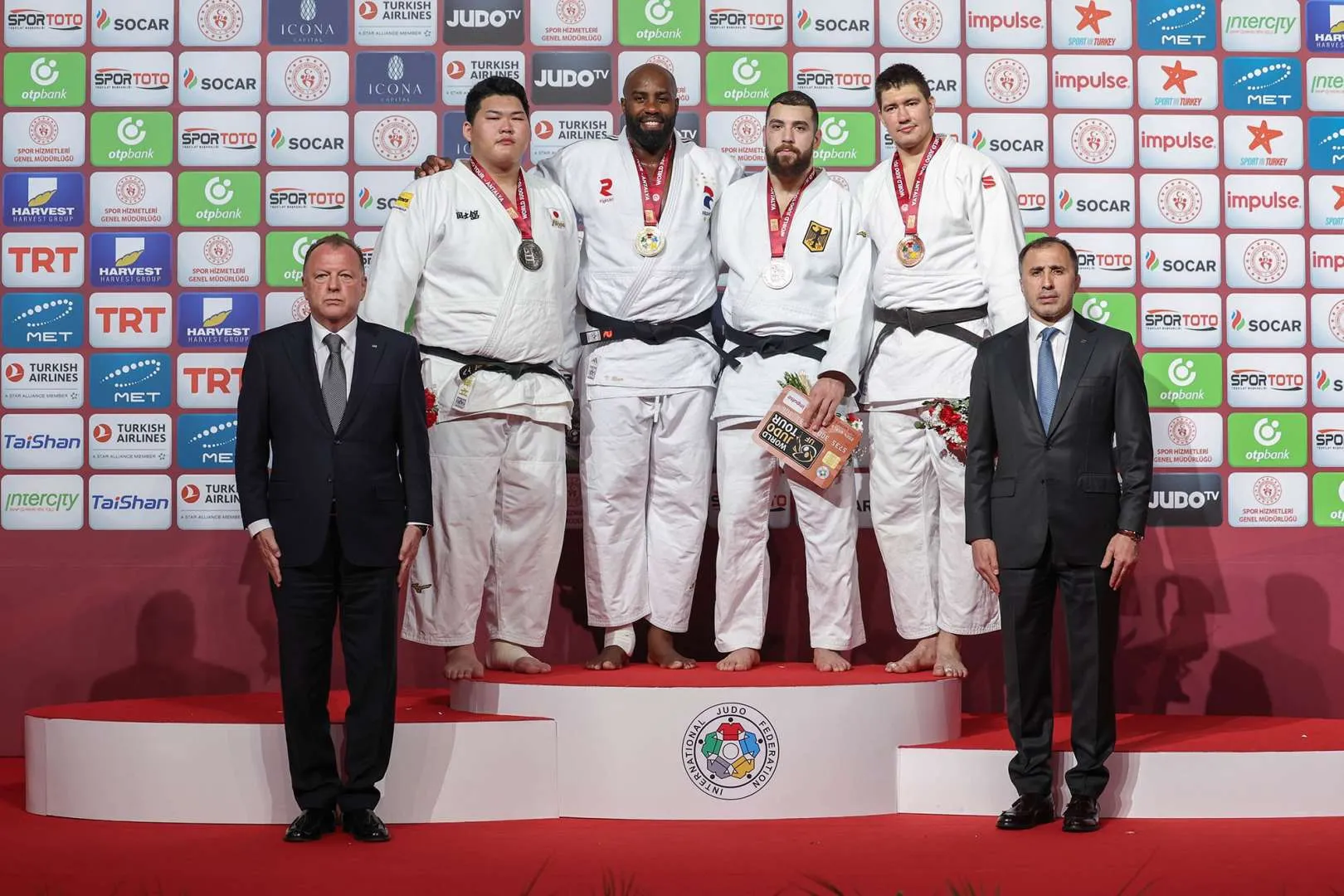 Teddy Riner with judo team on podium