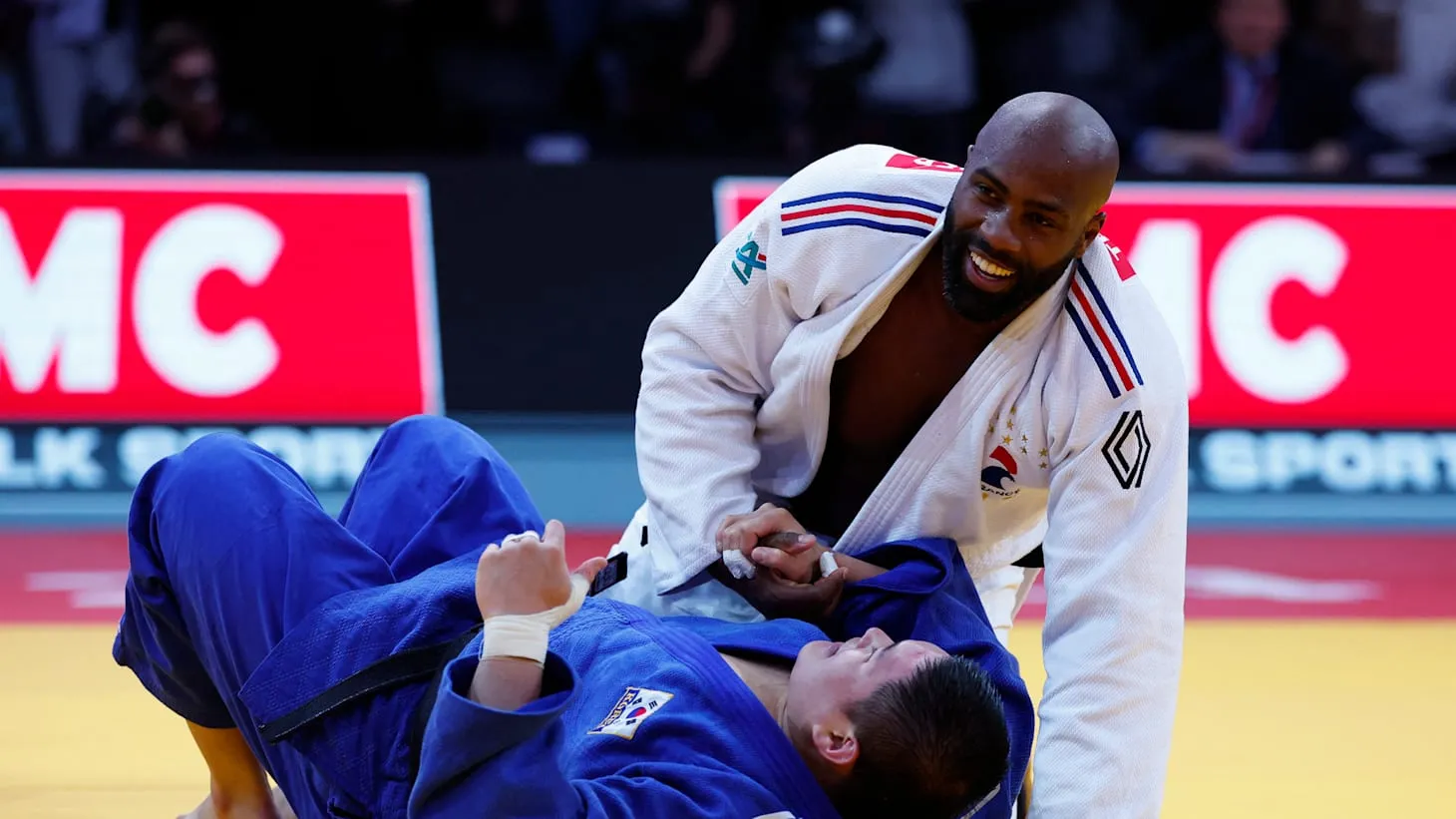 Teddy Riner in white gi controls match