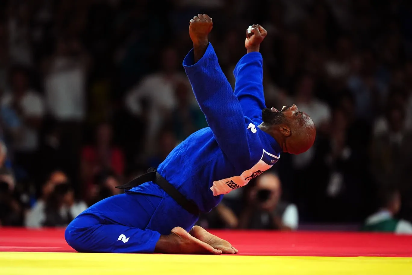Teddy Riner grappling in blue gi