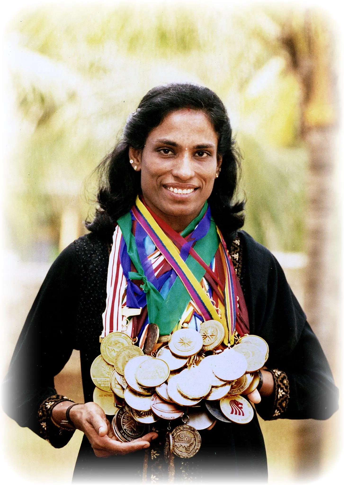 PT Usha Holding Her Medals  a Legacy of Excellence