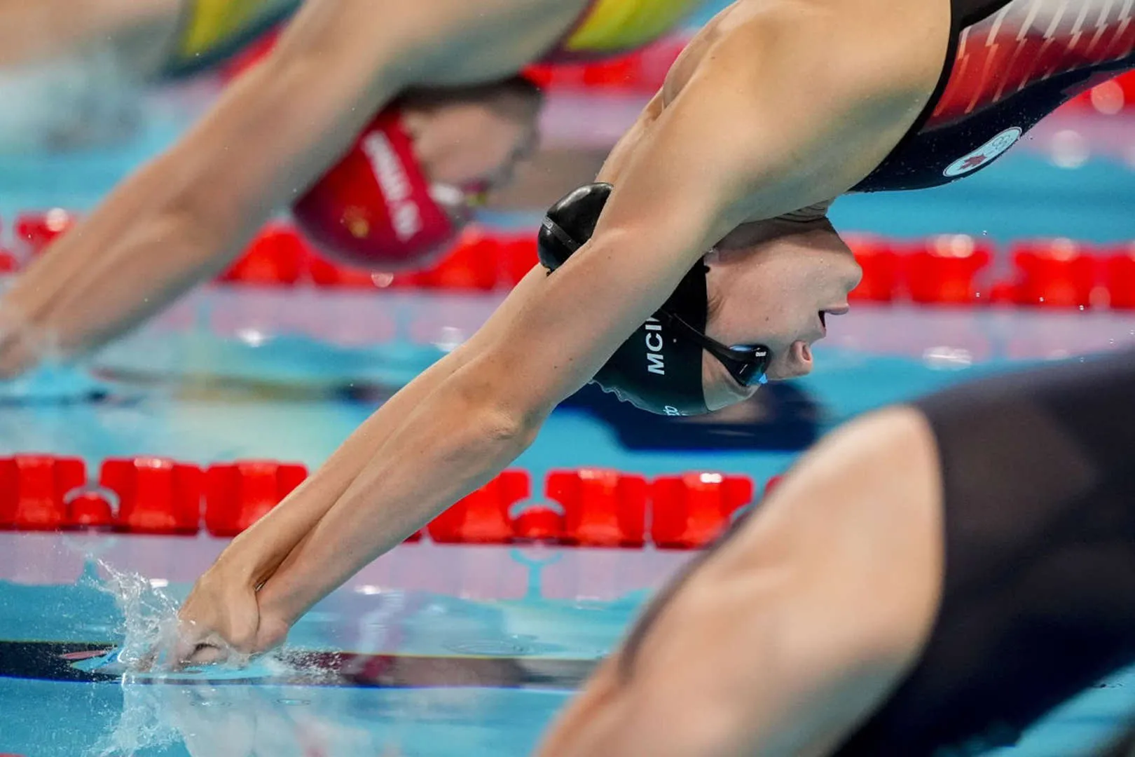 Summer McIntosh Diving into Action at Competitive Swimming Start Line