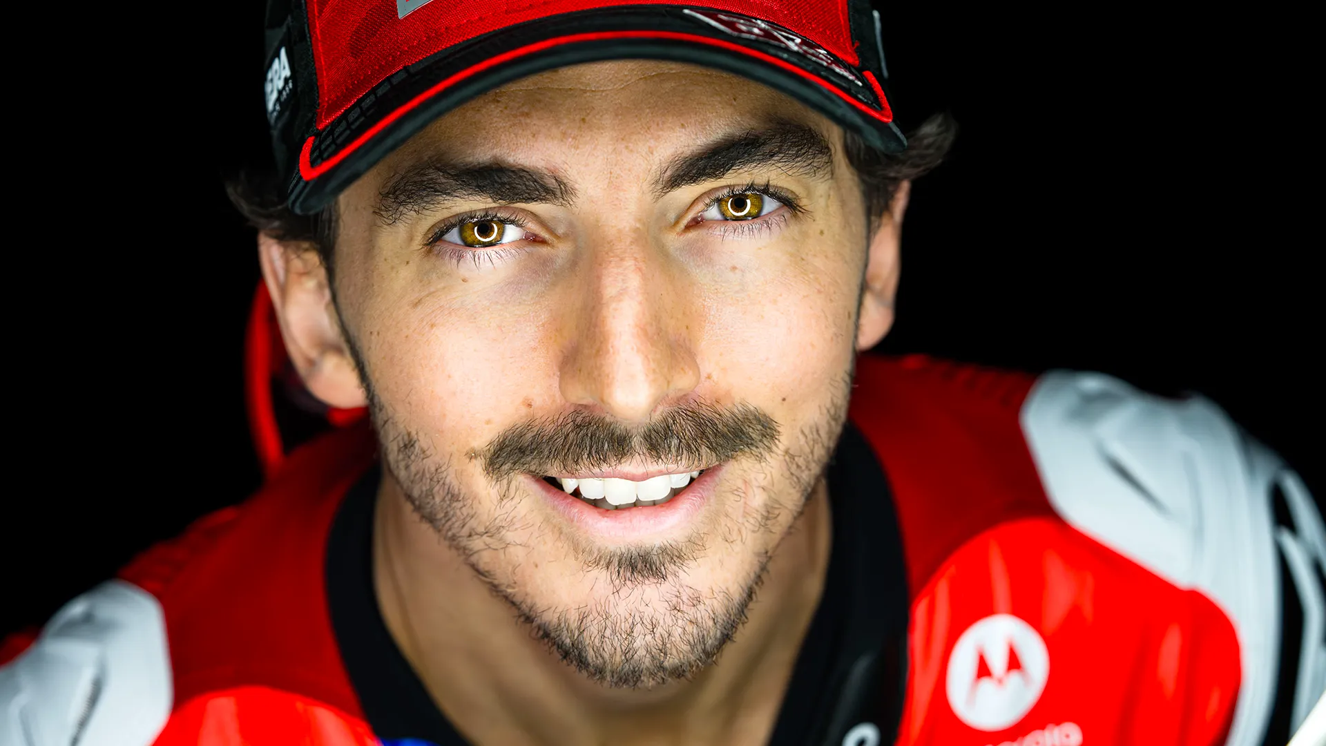 Close-up portrait of Francesco Bagnaia smiling