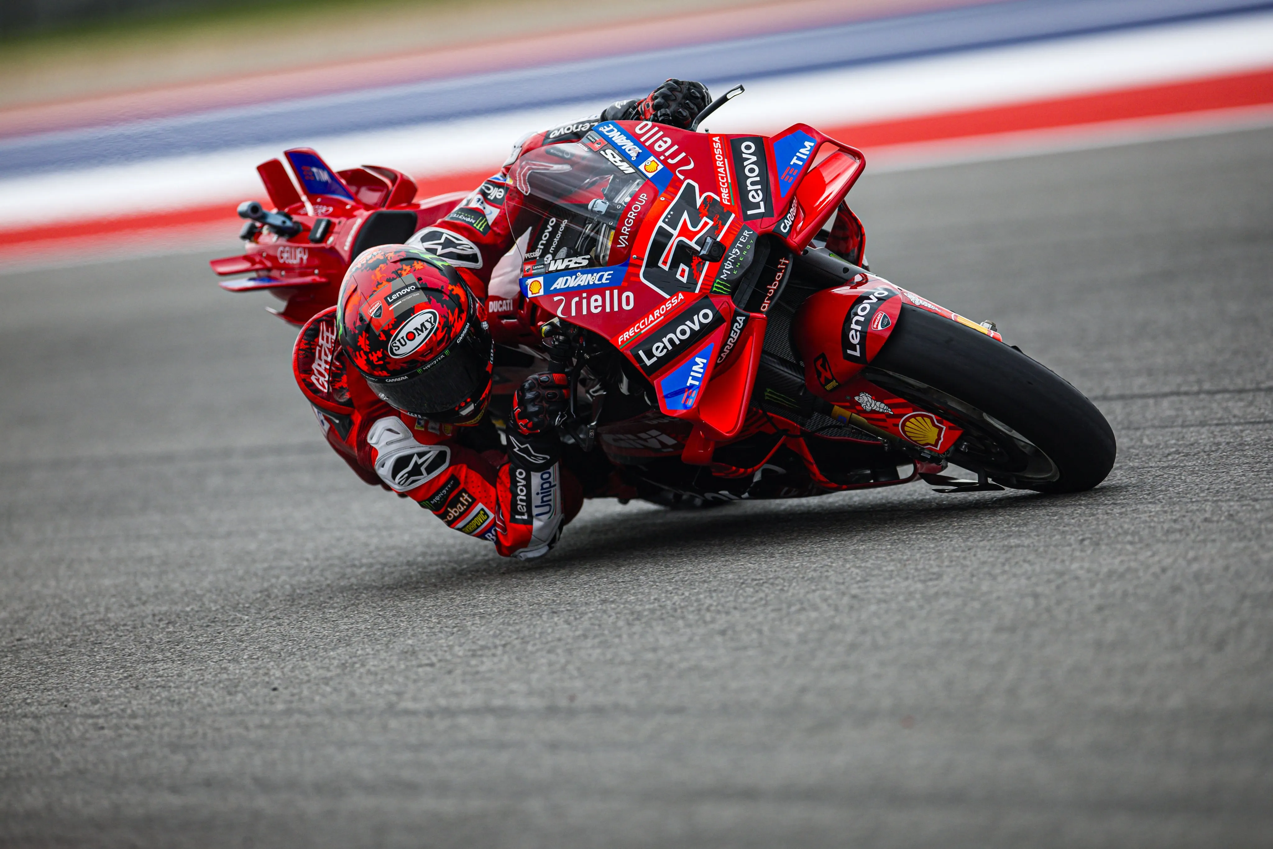 Francesco Bagnaia leaning into a sharp turn on the track