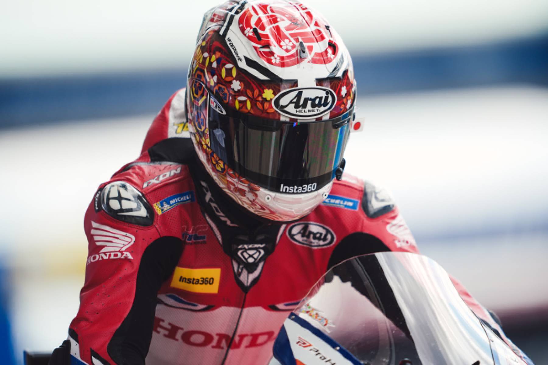 Luca Marini in Honda Racing Suit with Helmet On