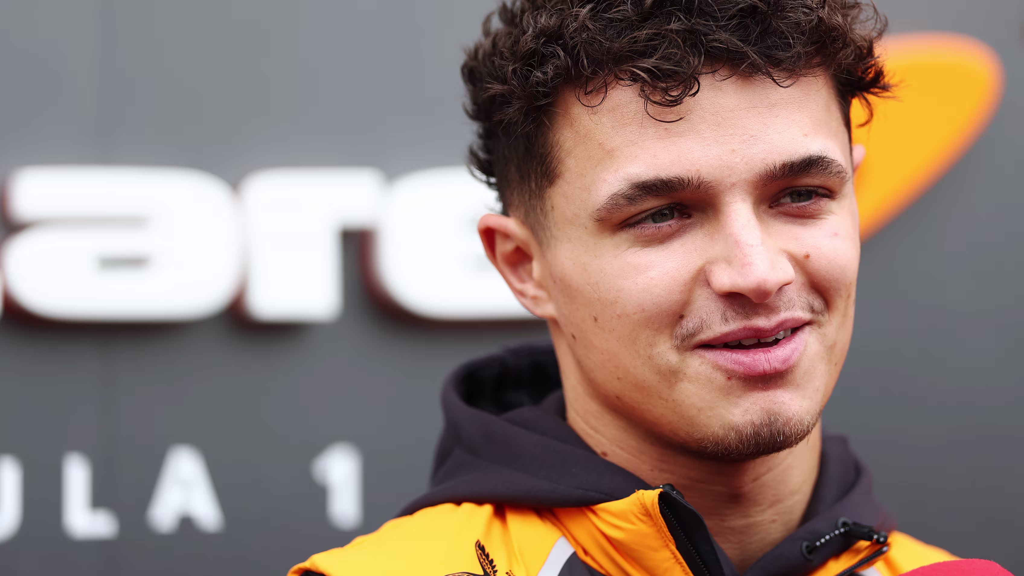 Smiling Lando Norris Shares a Light Moment During F1 Event