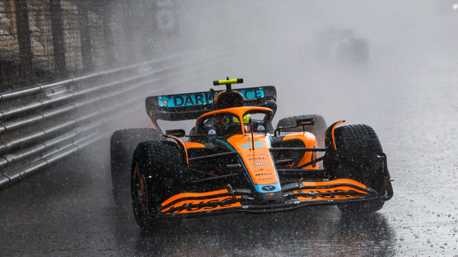 McLaren F1 Car Powers Through Rain in Challenging Wet Race