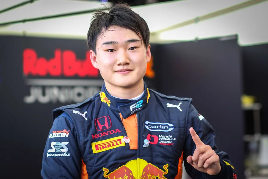 Confident Yuki Tsunoda Smiles in Red Bull Racing Outfit