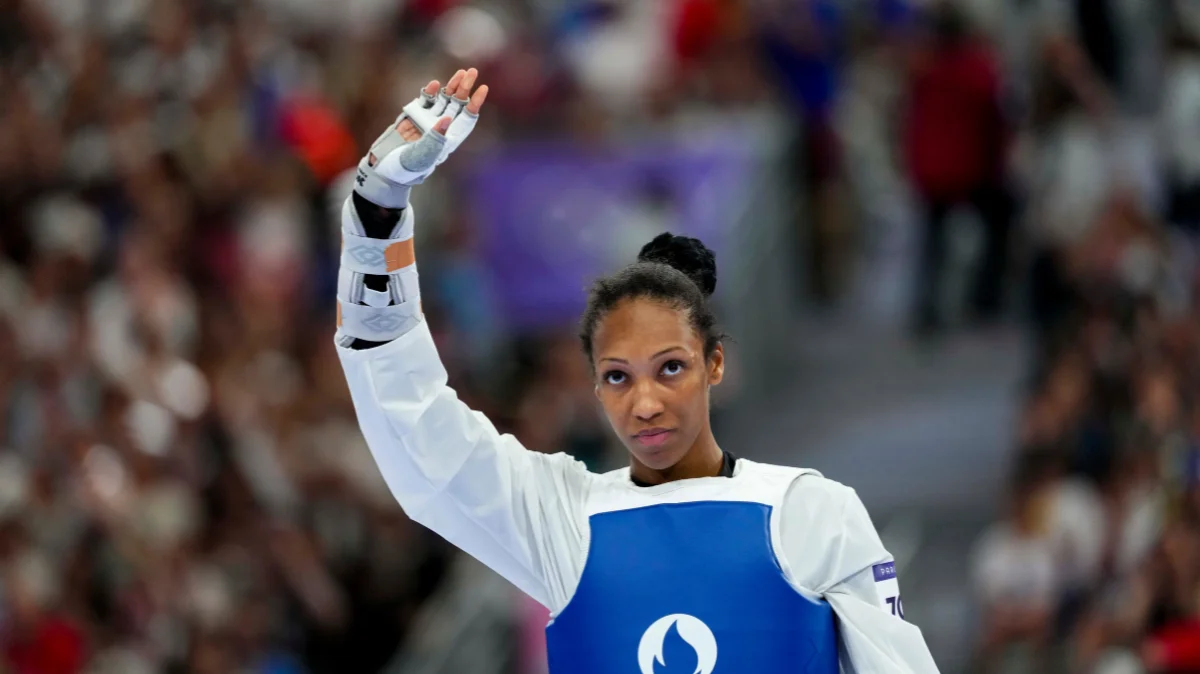 Althea Laurin Waving to Fans After Winning Taekwondo Match