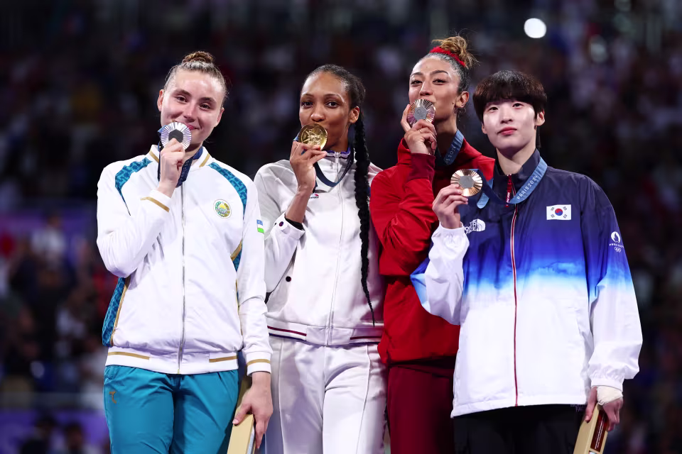 Althea Laurin Posing with Fellow Medalists on Podium