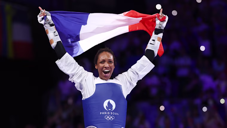 Althea Laurin Celebrating Taekwondo Victory with Flag