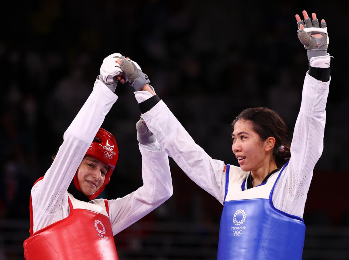 Victory Hand Raise in Taekwondo Match