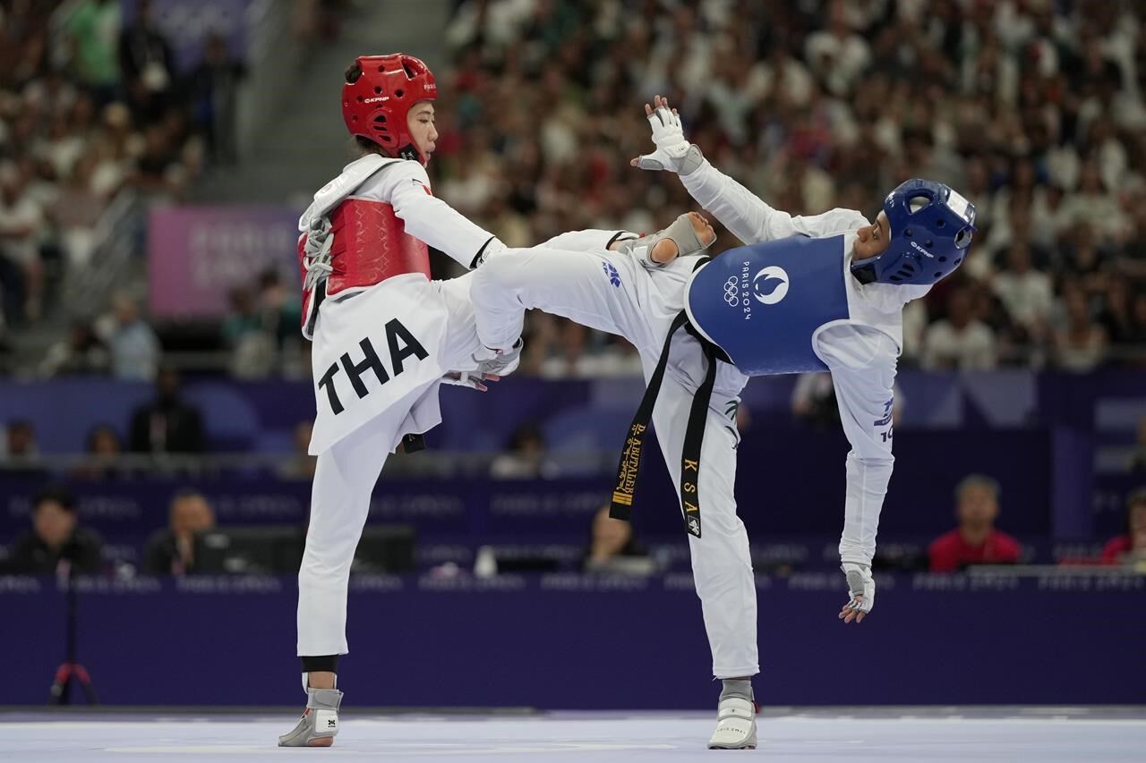 Taekwondo Match Action: Panipak Executes a Kick