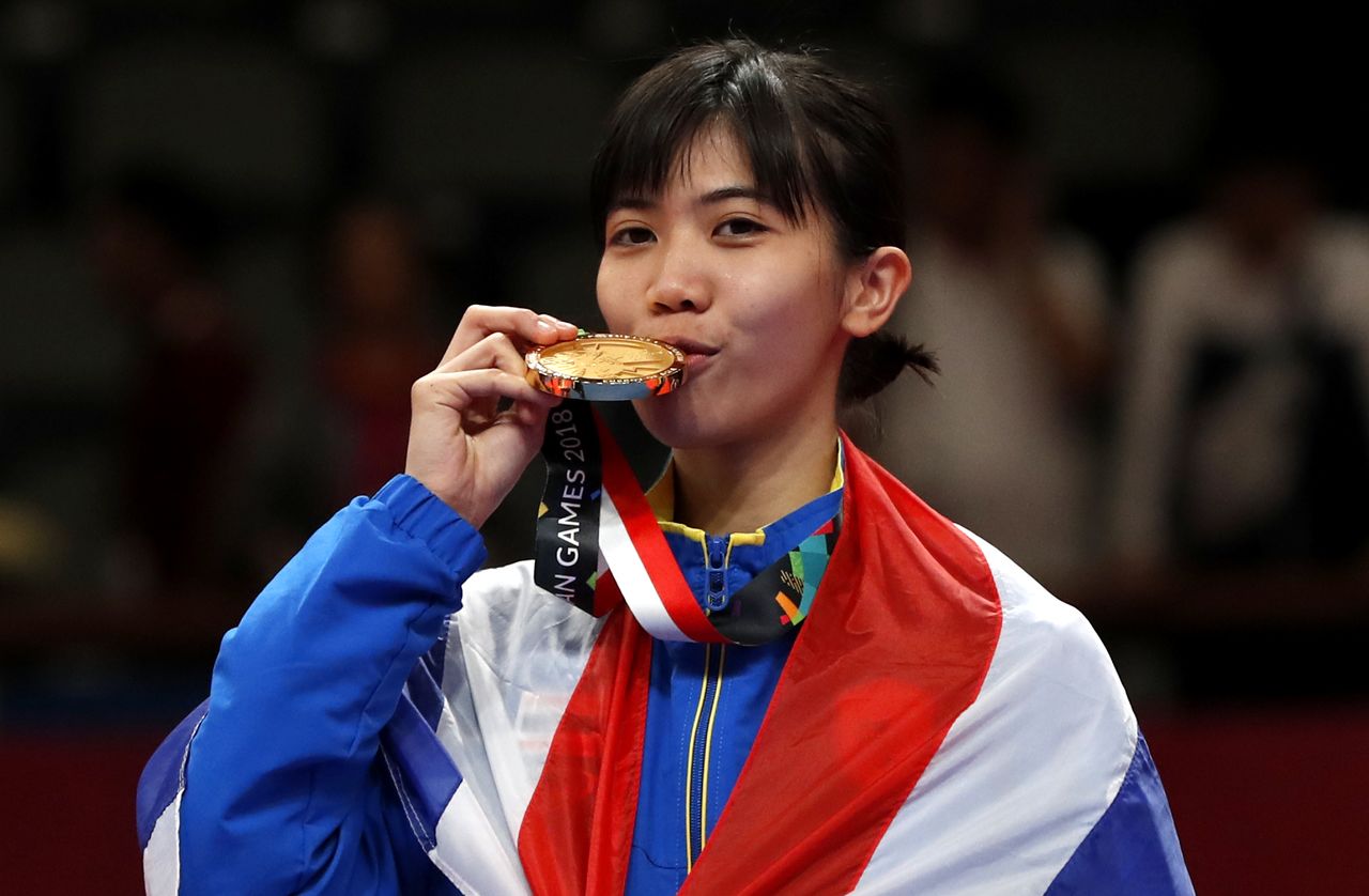 Panipak Biting Her Medal in Celebration