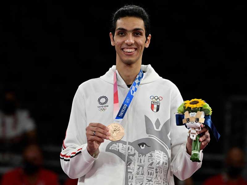 Seif Eissa Displaying Olympic Bronze Medal in Taekwondo Event