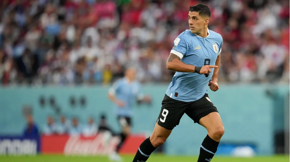 Luis Suarez runs with focus in Uruguay national team kit
