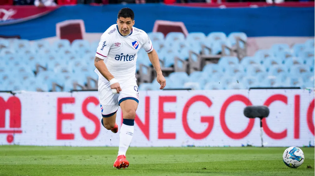 Luis Suarez plays in white kit during club football match