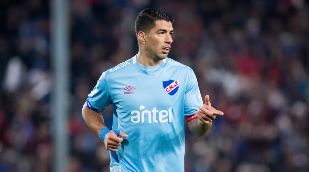 Luis Suarez prepares for kickoff in Nacional football kit