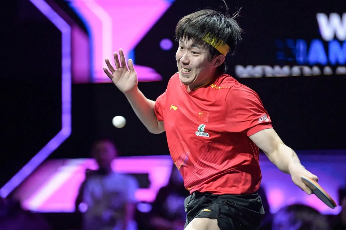 Wang Chuqin Celebrates with Partner On Court