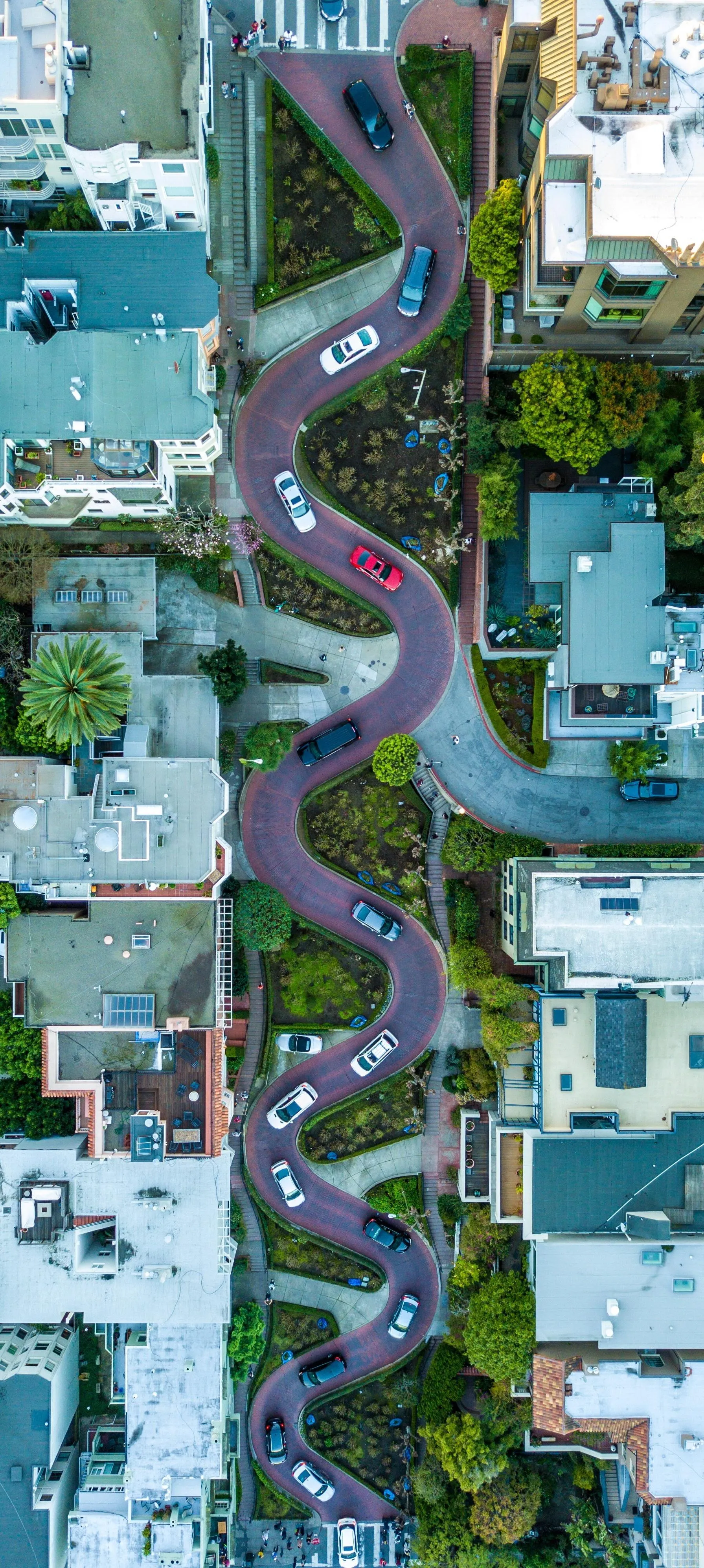 Aerial City Road in Zigzag Pattern Through Suburb Area