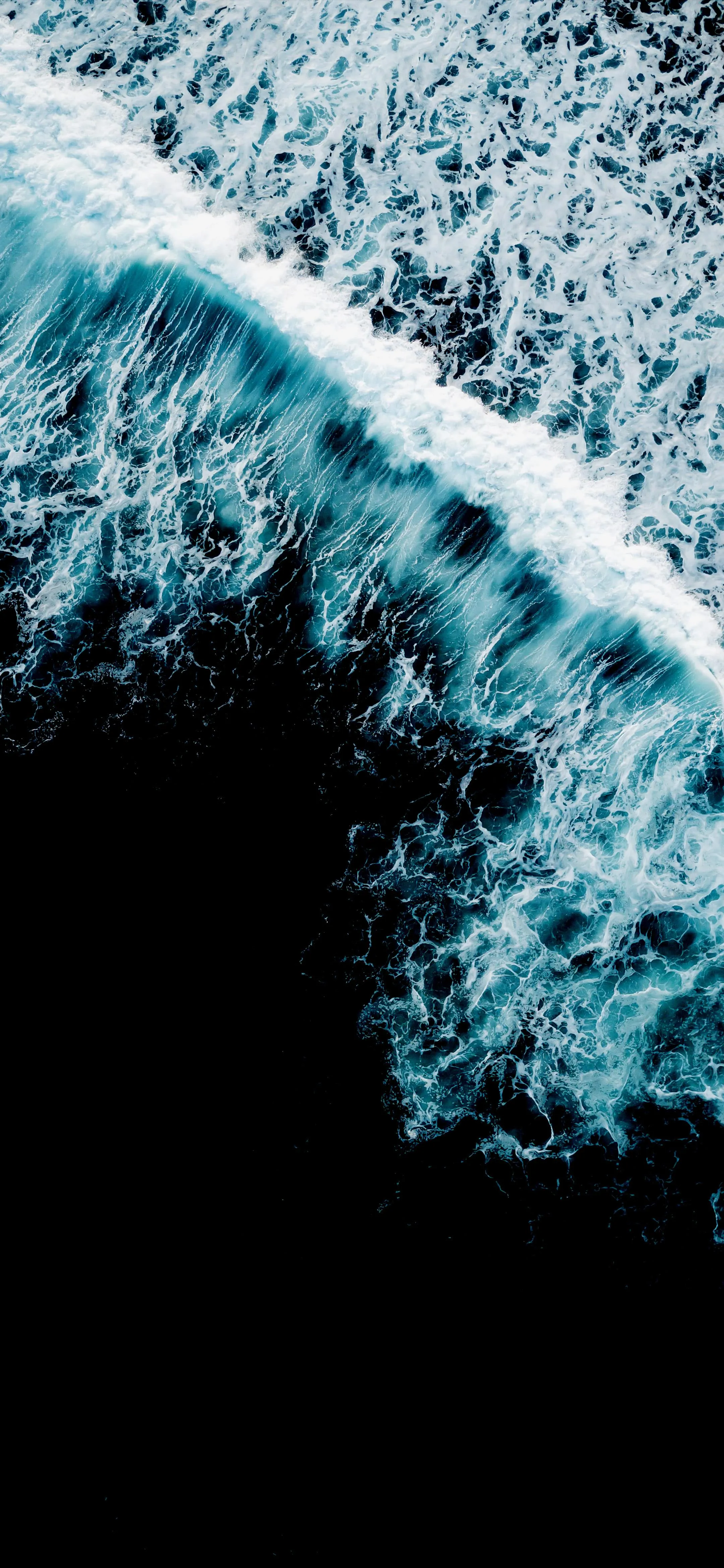 Aerial Ocean Wave Crashing on Deep Black Shore Wallpaper