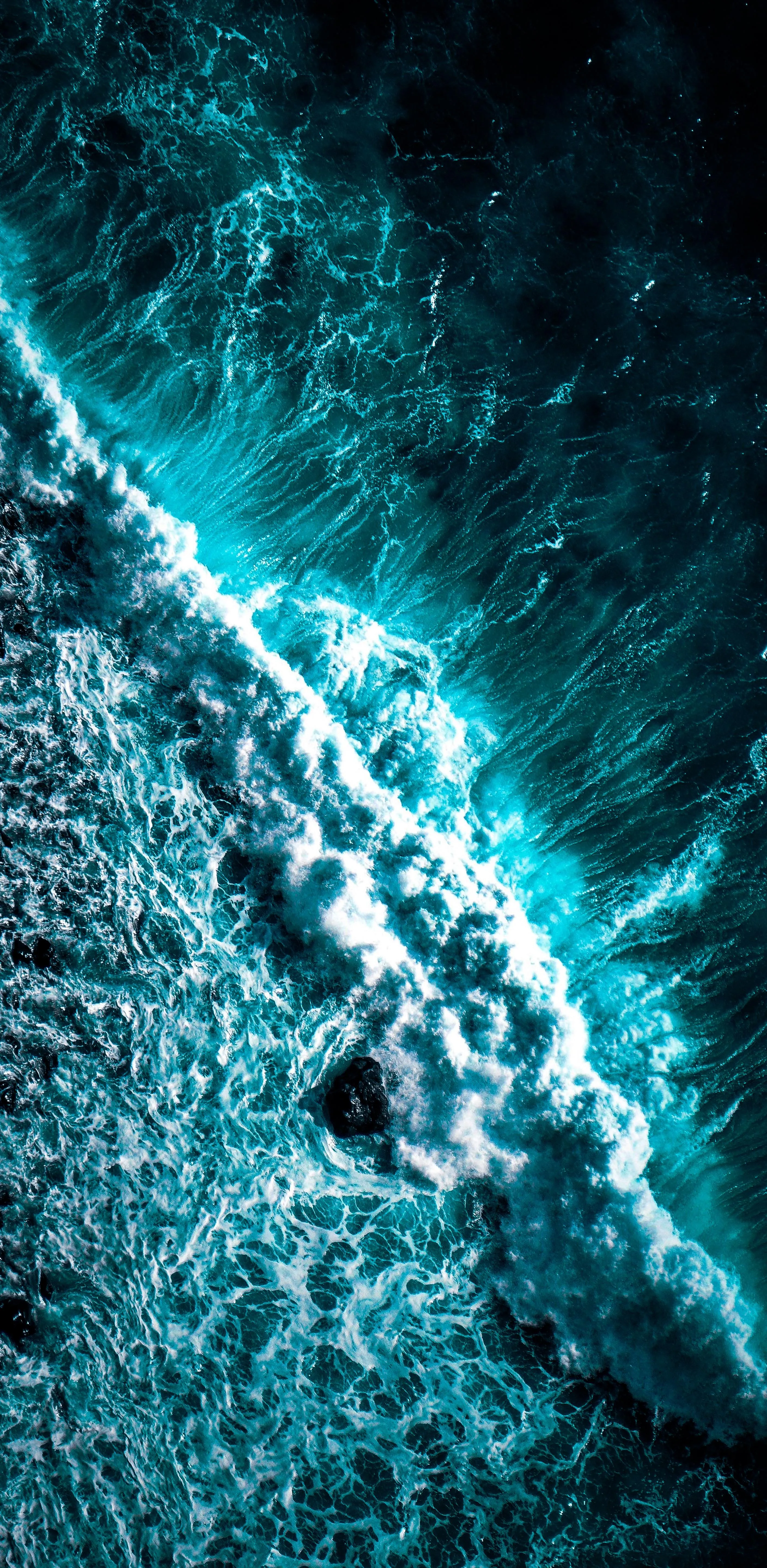 Aerial Ocean Waves Crashing on Rocky Shoreline View Image